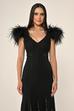 Long knitted evening dress with ostrich feathers on the shoulders, sequined waist, back and hem.