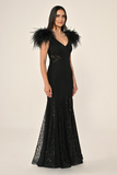 Long knitted evening dress with ostrich feathers on the shoulders, sequined waist, back and hem.