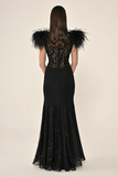 Long knitted evening dress with ostrich feathers on the shoulders, sequined waist, back and hem.